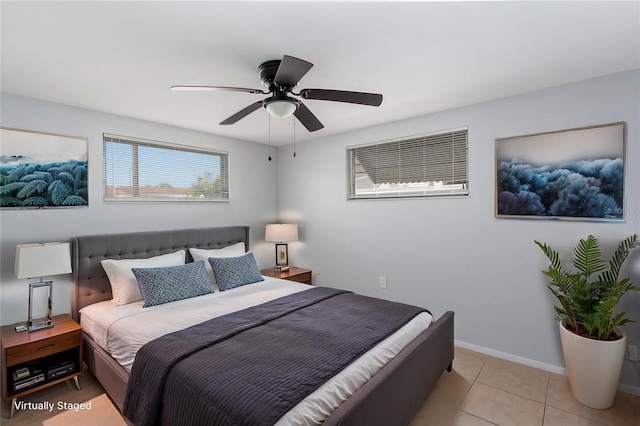 bedroom with light tile patterned floors, baseboards, and a ceiling fan