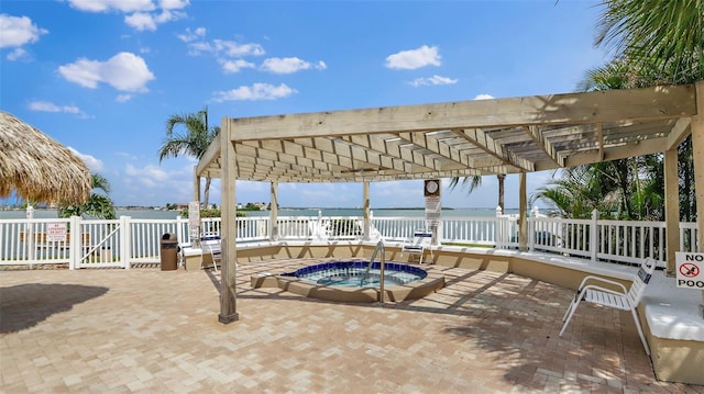 6322 Palma Del Mar Blvd S Unit 706, Saint Petersburg, FL 33715 - view of patio / terrace featuring a pergola, fence, a hot tub, and a water view