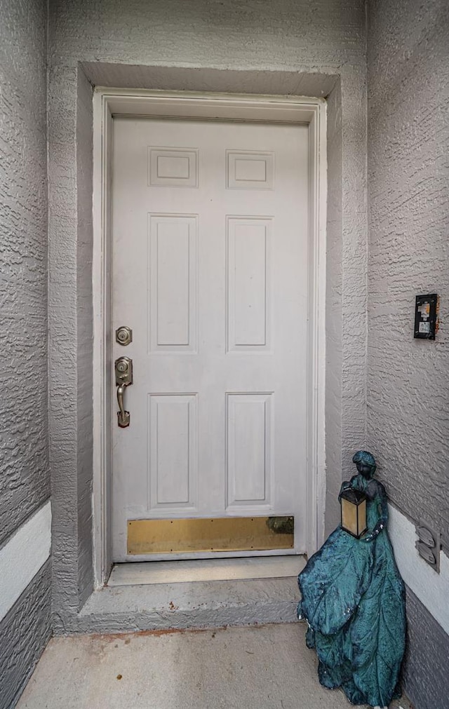 doorway to property with stucco siding