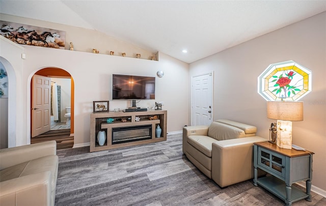 living area with arched walkways, baseboards, lofted ceiling, and recessed lighting