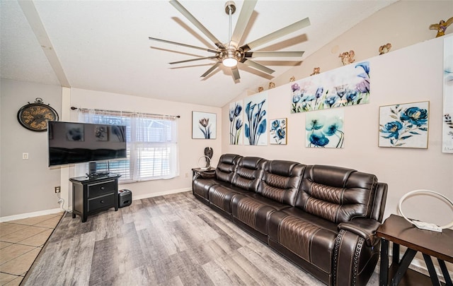 living room featuring baseboards, a ceiling fan, wood finished floors, and lofted ceiling