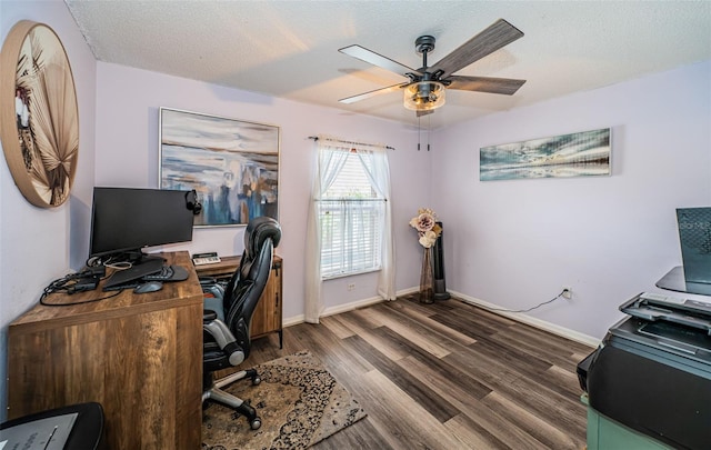 home office with dark wood-type flooring, baseboards, a textured ceiling, and ceiling fan