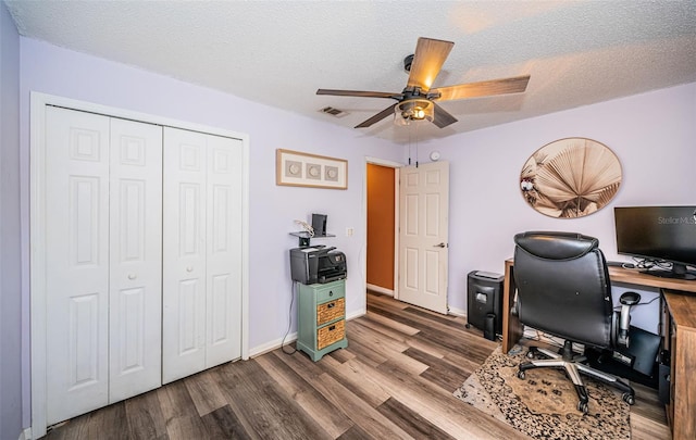 office space with dark wood-style flooring, visible vents, a ceiling fan, and a textured ceiling