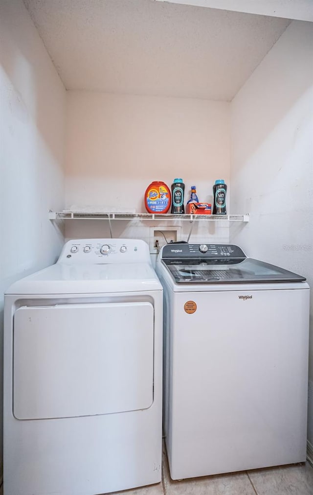 clothes washing area with washer and dryer and laundry area