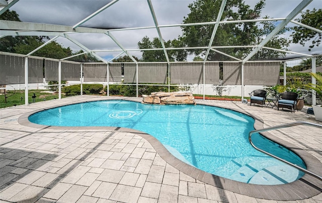 outdoor pool with a patio and a lanai