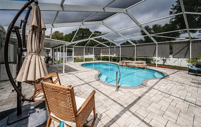 view of pool with glass enclosure, a fenced in pool, and a patio
