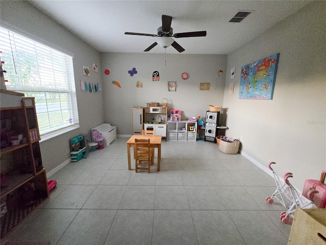 recreation room with visible vents, baseboards, a ceiling fan, and tile patterned flooring