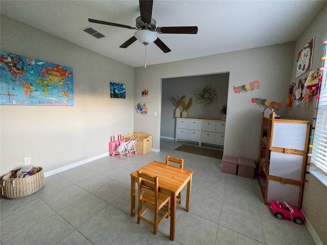 game room featuring ceiling fan, baseboards, tile patterned flooring, and visible vents