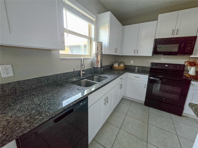 kitchen with white cabinetry, a sink, black appliances, and dark stone counters