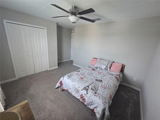 bedroom with baseboards, carpet flooring, a closet, and a ceiling fan