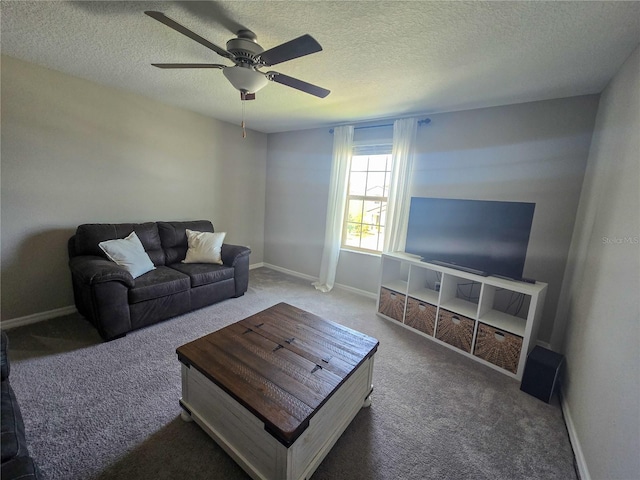 carpeted living room with a textured ceiling, baseboards, and ceiling fan