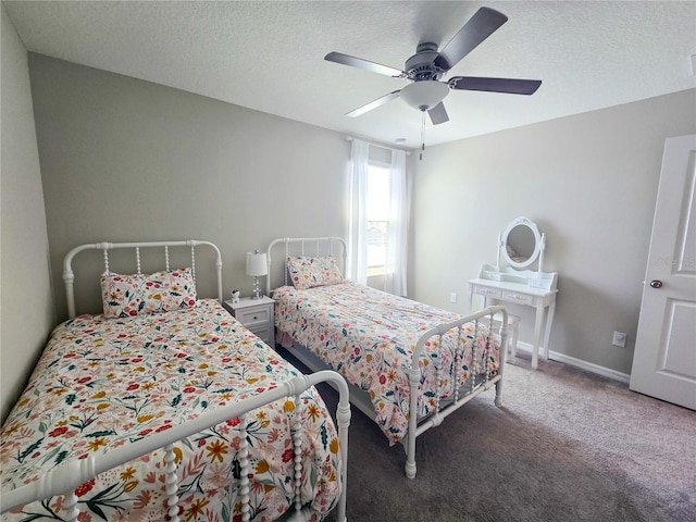 carpeted bedroom featuring a textured ceiling and a ceiling fan