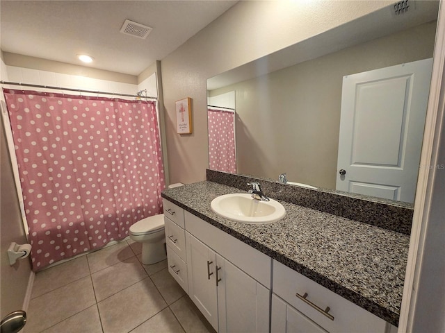 full bath featuring toilet, tile patterned floors, vanity, and visible vents