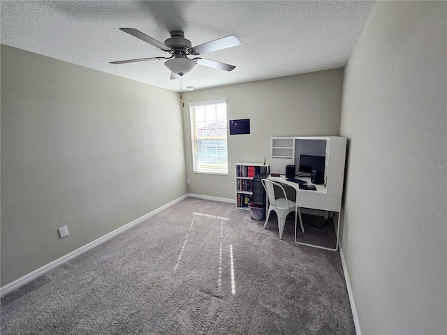 carpeted office space featuring baseboards, a textured ceiling, and a ceiling fan