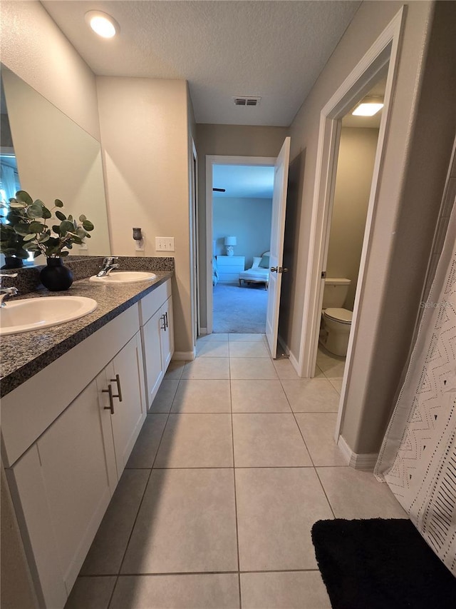 full bath with tile patterned flooring, visible vents, a sink, and toilet