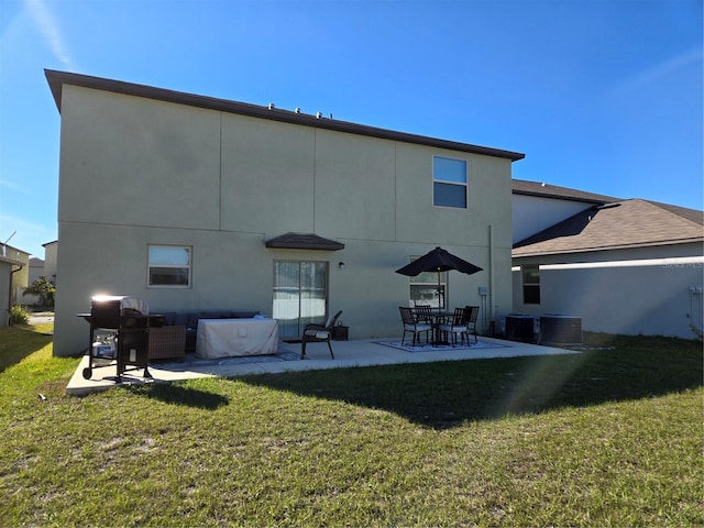 rear view of property featuring a patio area, central air condition unit, stucco siding, and a lawn