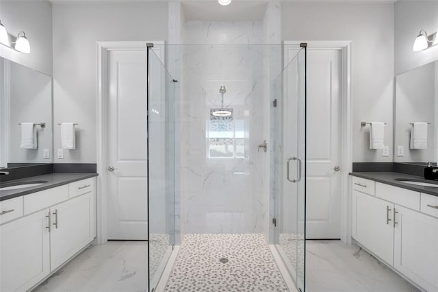 full bath with two vanities, marble finish floor, a sink, and a marble finish shower