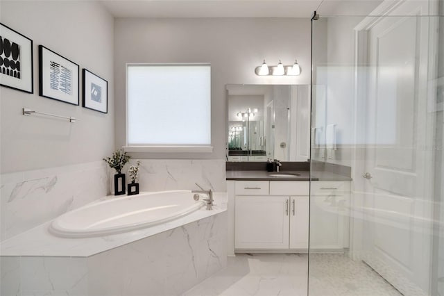 full bathroom with vanity, marble finish floor, a stall shower, and a garden tub