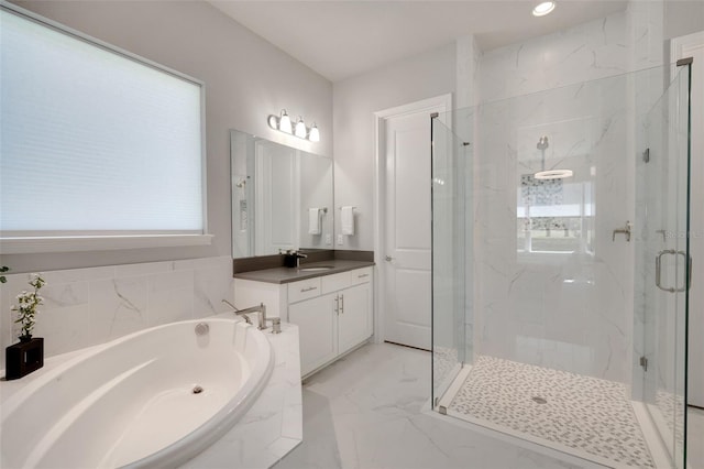 full bathroom featuring a marble finish shower, a bath, plenty of natural light, and vanity