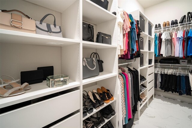spacious closet with marble finish floor
