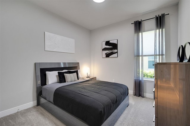 carpeted bedroom featuring baseboards