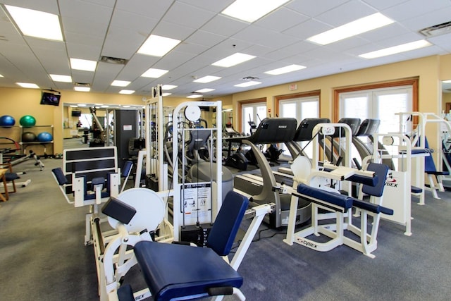 exercise room with visible vents and a drop ceiling