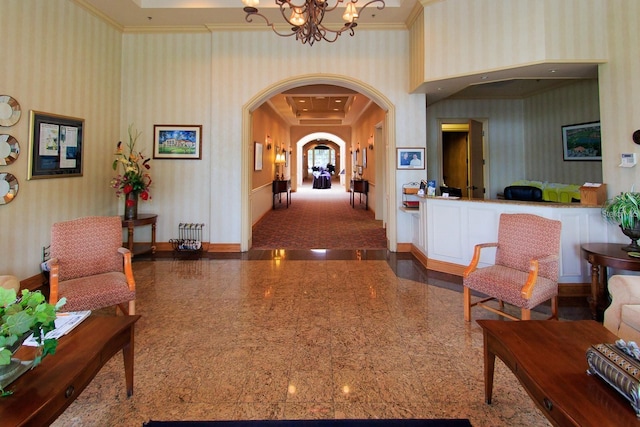 hallway featuring baseboards, arched walkways, granite finish floor, and wallpapered walls