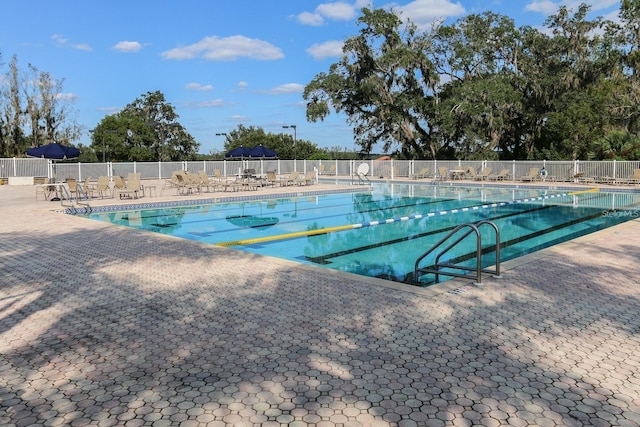 pool featuring a patio and fence