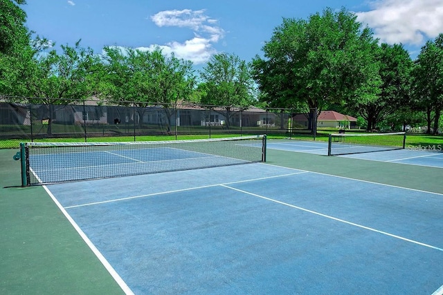 view of tennis court with fence