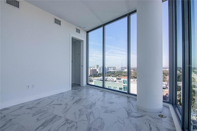 777 3rd Ave N Unit 1501, Saint Petersburg, FL 33701 - empty room with expansive windows, marble finish flooring, baseboards, and a city view