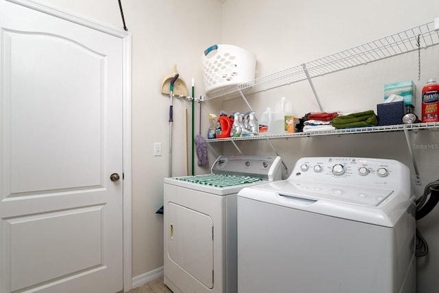laundry room featuring washer and clothes dryer, laundry area, and baseboards
