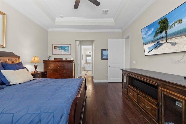 bedroom featuring a raised ceiling, crown molding, dark wood-style floors, and visible vents