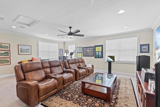 living area featuring baseboards, a ceiling fan, attic access, crown molding, and visible vents