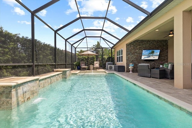 outdoor pool featuring outdoor lounge area, a patio, ceiling fan, and a lanai
