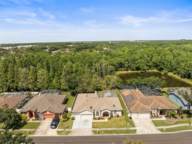 birds eye view of property featuring a water view and a forest view