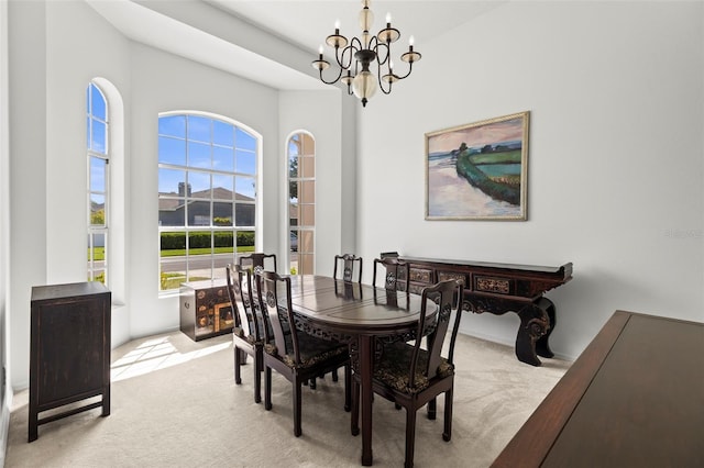 dining area with a notable chandelier and light carpet