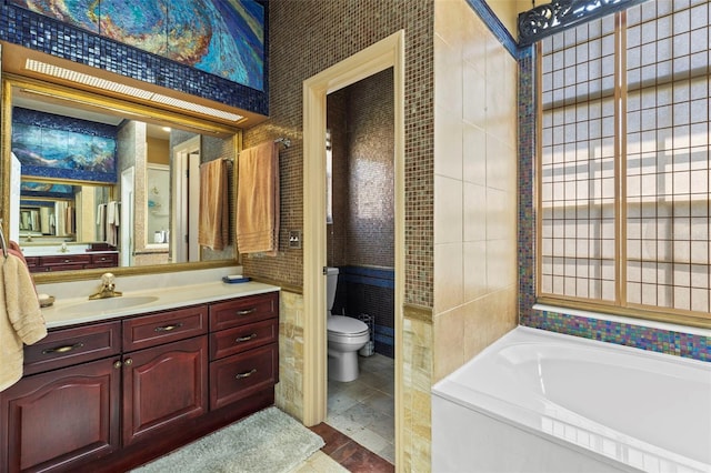 full bath featuring a bath, toilet, and vanity