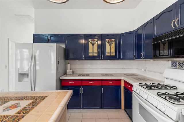 kitchen with white appliances and blue cabinets