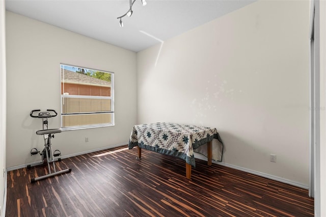bedroom featuring wood finished floors and baseboards