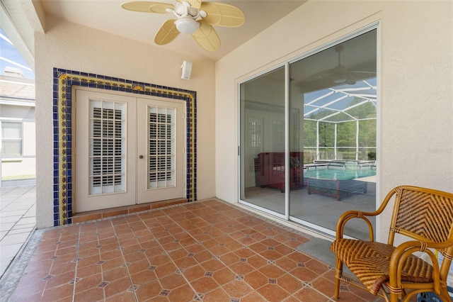view of patio / terrace featuring a lanai, french doors, and a ceiling fan