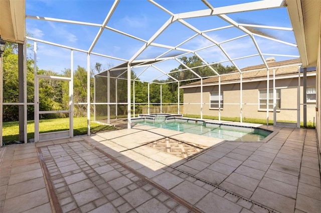 view of swimming pool featuring a patio area, a pool with connected hot tub, and a lanai