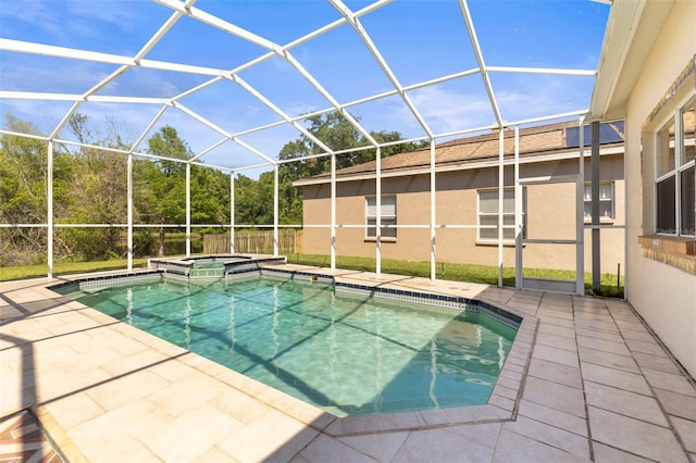 view of pool with a lanai, a patio, and a pool with connected hot tub