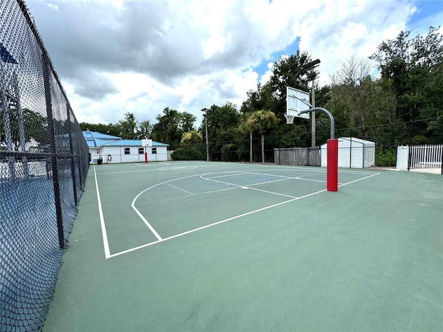 view of basketball court with community basketball court and fence