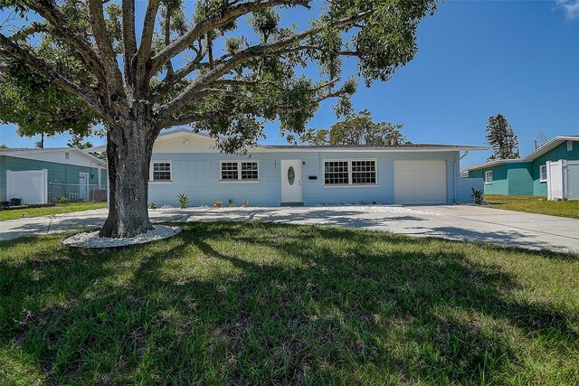 3841 Wahoo Dr SE, Saint Petersburg, FL 33705 - ranch-style house with a garage, a front yard, and concrete driveway