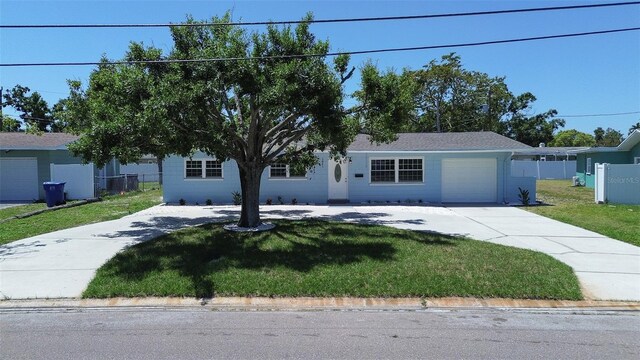 3841 Wahoo Dr SE, Saint Petersburg, FL 33705 - single story home with an attached garage, concrete driveway, fence, and a front lawn