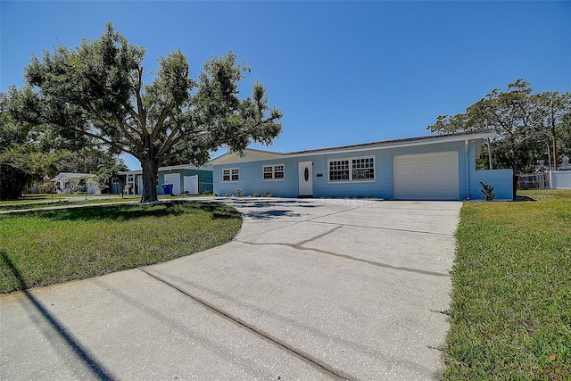3841 Wahoo Dr SE, Saint Petersburg, FL 33705 - single story home featuring a front yard, an attached garage, fence, and concrete driveway