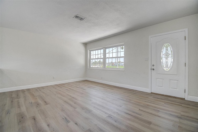 3841 Wahoo Dr SE, Saint Petersburg, FL 33705 - foyer featuring visible vents, a wealth of natural light, wood finished floors, and baseboards