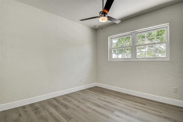 3841 Wahoo Dr SE, Saint Petersburg, FL 33705 - empty room with a wealth of natural light, baseboards, and wood finished floors