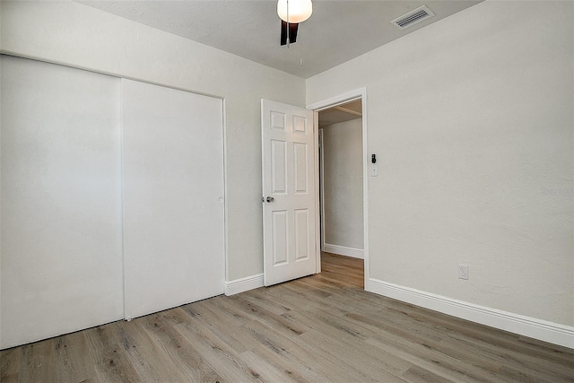 3841 Wahoo Dr SE, Saint Petersburg, FL 33705 - unfurnished bedroom featuring ceiling fan, a closet, visible vents, wood finished floors, and baseboards