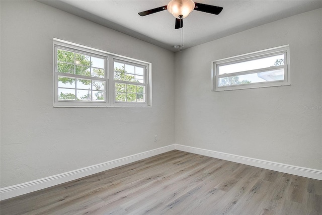 3841 Wahoo Dr SE, Saint Petersburg, FL 33705 - unfurnished room with wood finished floors, baseboards, and a wealth of natural light